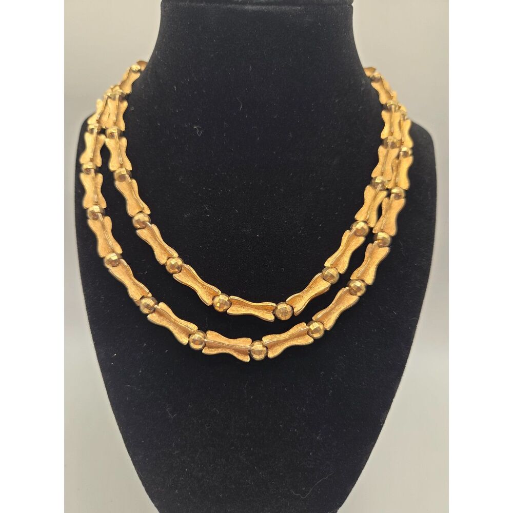 1842. Vintage Gold Tone Bow and Bones Necklace